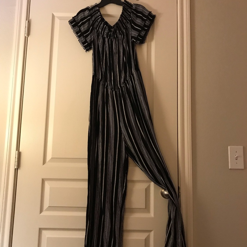 NEW WITH TAGS. Xhilaration black and white striped jumpsuit. Size Medium.